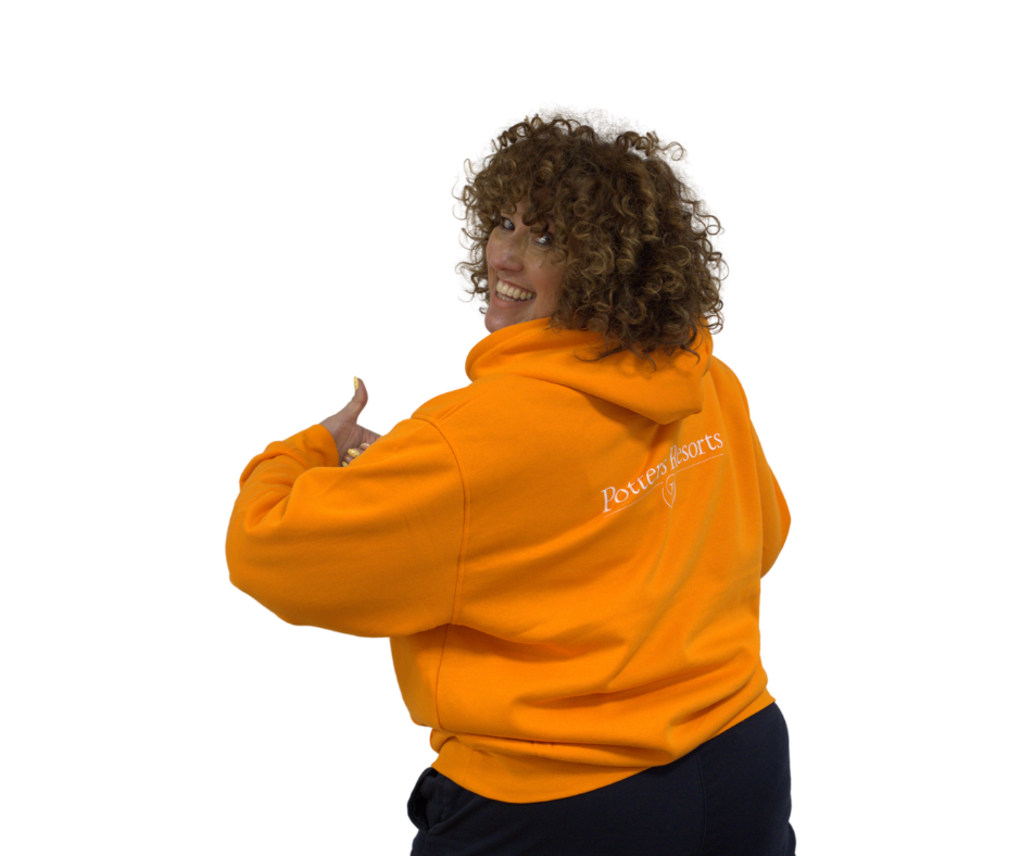 Person wearing an orange hoodie with text on a white background