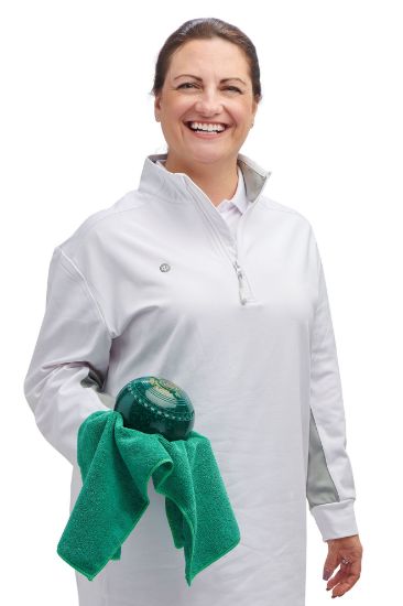 Woman holding a green ball and towel against a white background