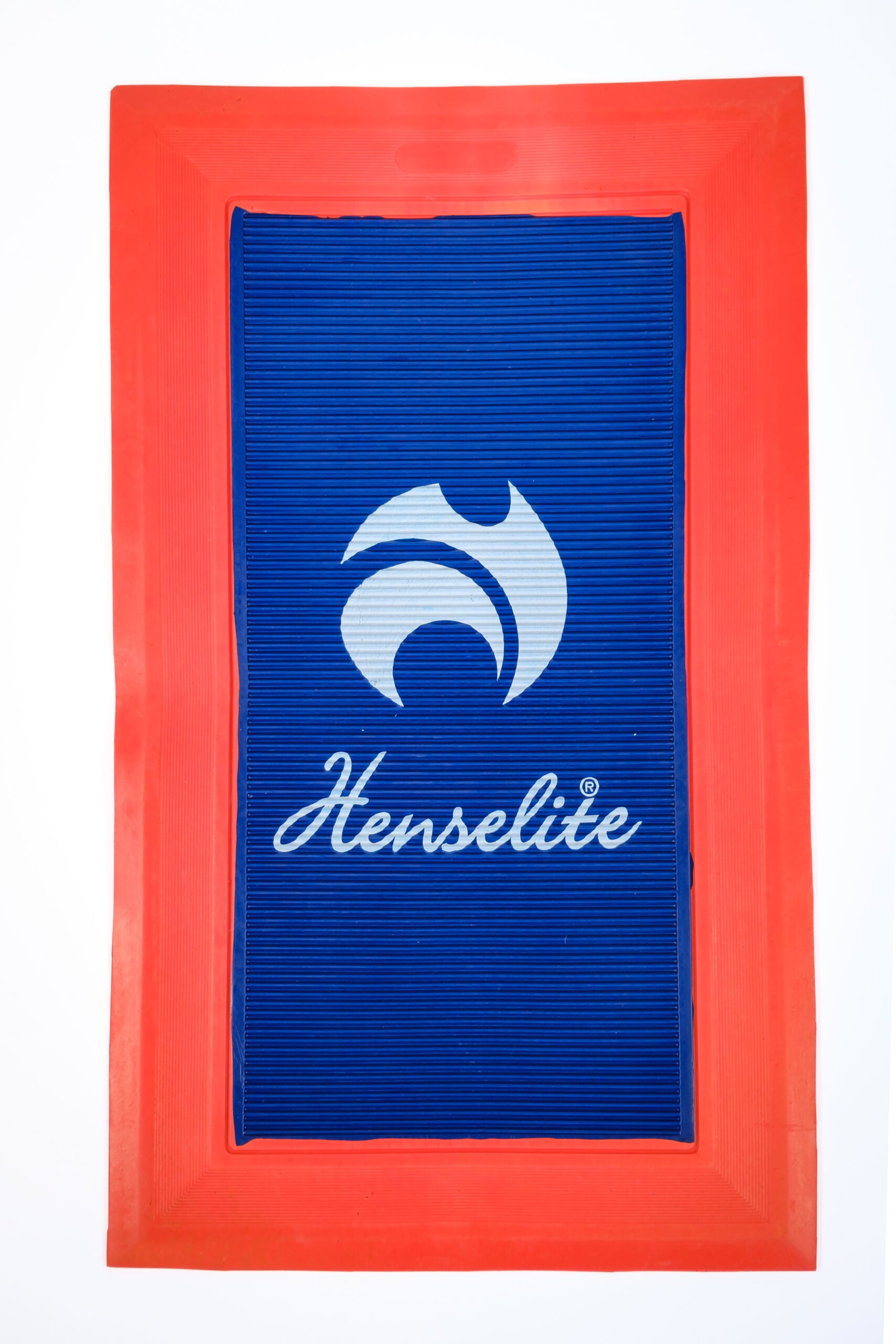 A red and blue delivery mat with the Henselite logo printed in white.