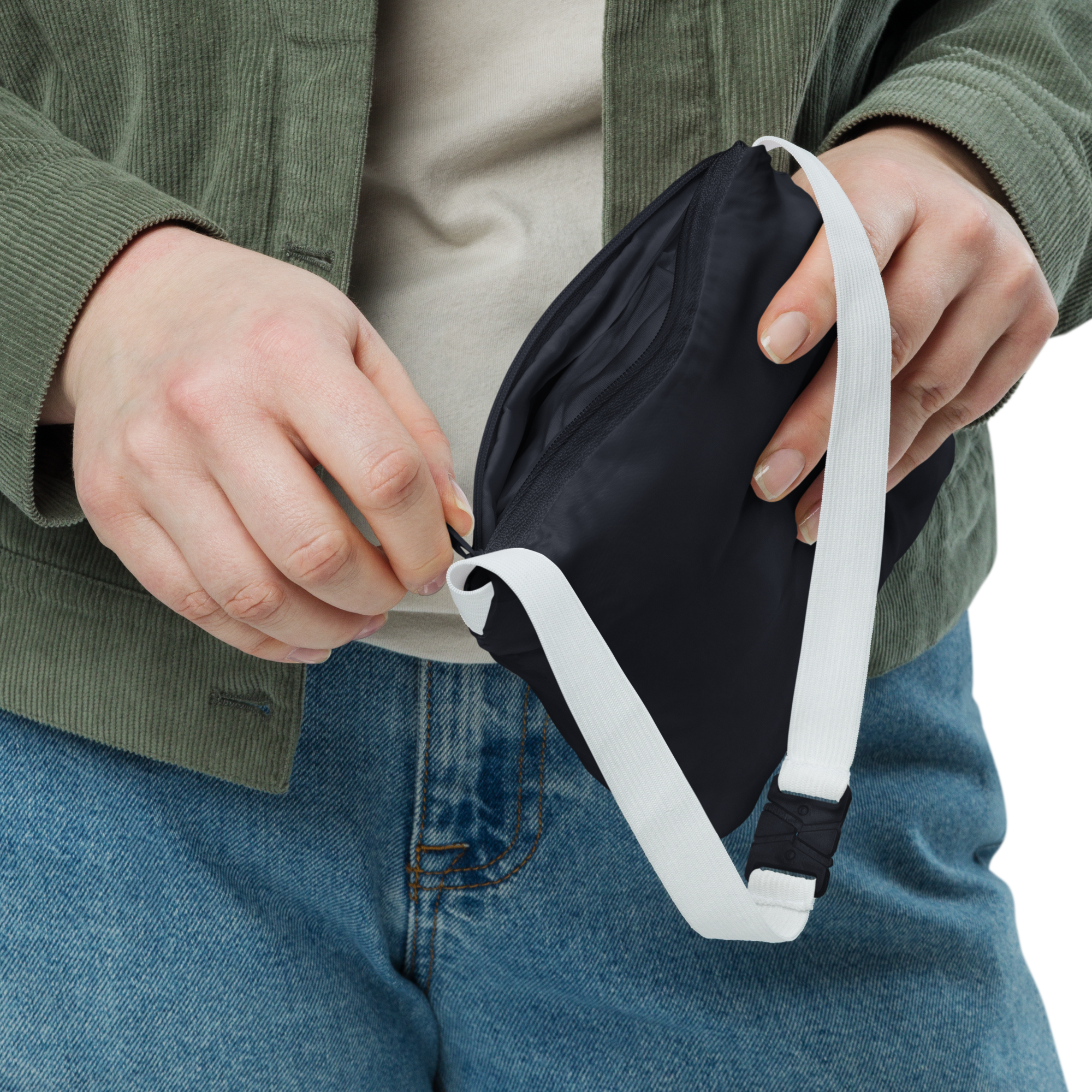 Person holding a black face mask with a white strap