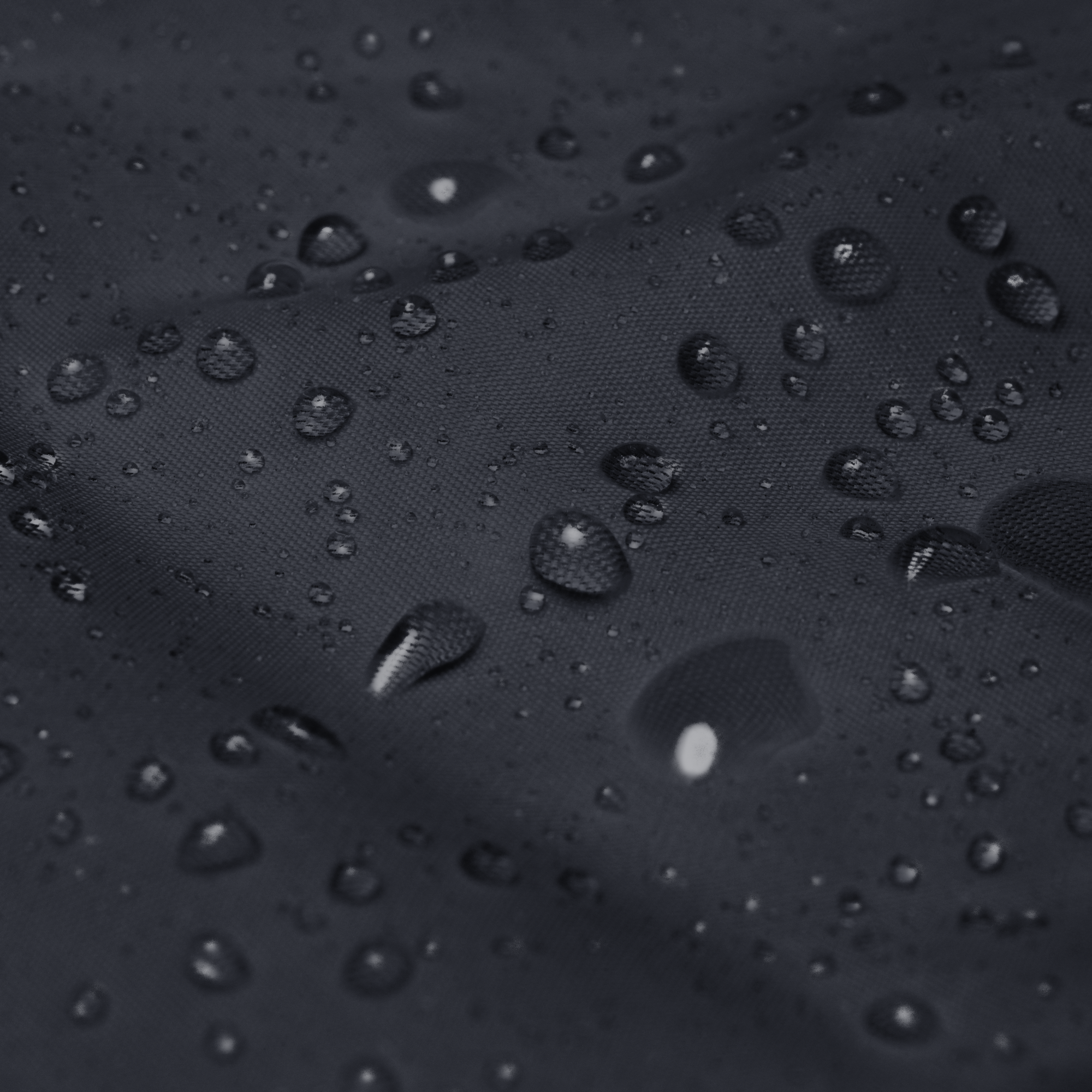 Water droplets on a dark textured surface
